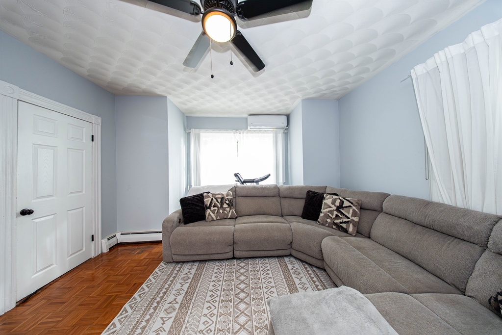 166 Bradford Avenue Fall River, MA 02721 - Photo 14 of 42 a living room with furniture and a rug