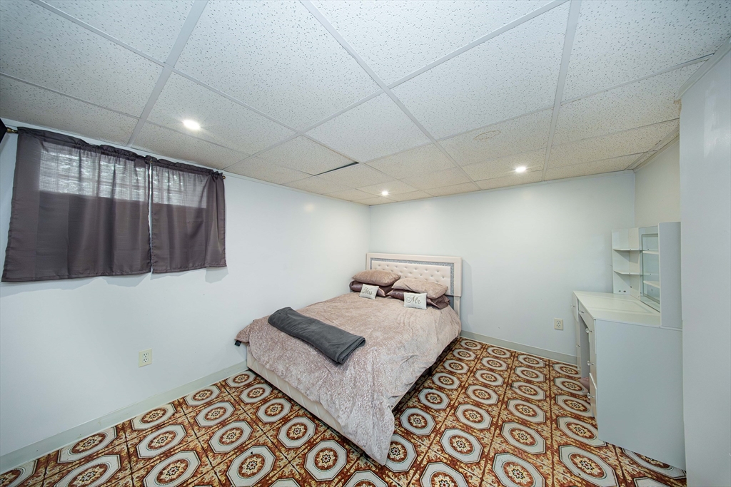166 Bradford Avenue Fall River, MA 02721 - Photo 21 of 42 a bedroom with a bed and a walk in closet