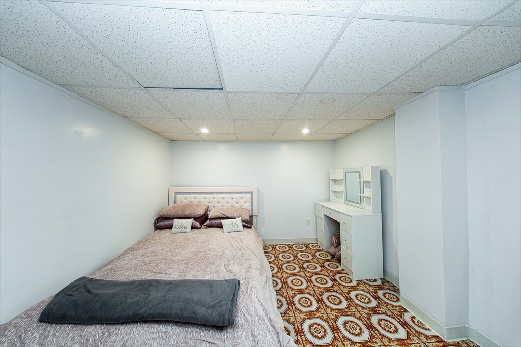 166 Bradford Avenue Fall River, MA 02721 - Photo 22 of 42 a bedroom with a bed and wooden floor