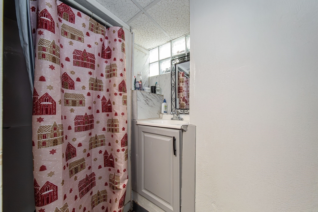 166 Bradford Avenue Fall River, MA 02721 - Photo 23 of 42 a bathroom with a sink and a mirror