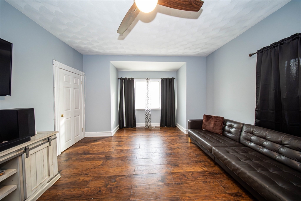 166 Bradford Avenue Fall River, MA 02721 - Photo 25 of 42 a living room with stainless steel appliances granite countertop a couch and a flat screen tv