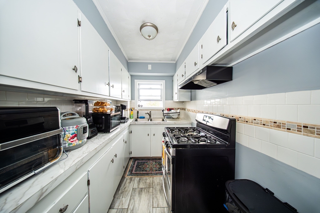 166 Bradford Avenue Fall River, MA 02721 - Photo 28 of 42 a kitchen with stainless steel appliances a stove a sink and a microwave