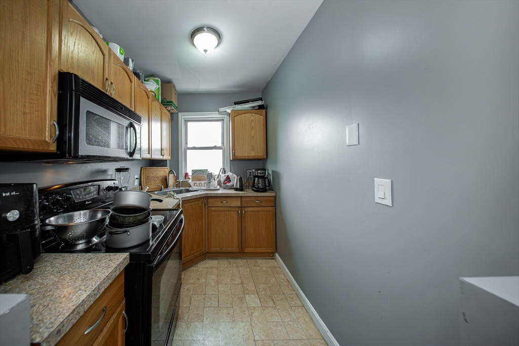 166 Bradford Avenue Fall River, MA 02721 - Photo 34 of 42 a kitchen with a sink stove and microwave
