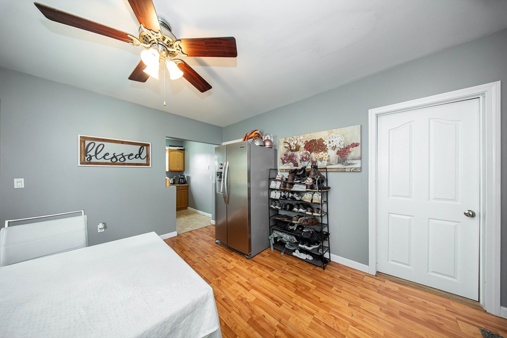 166 Bradford Avenue Fall River, MA 02721 - Photo 38 of 42 a bedroom with a large bed and a chandelier