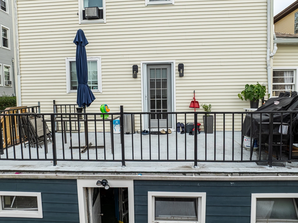 166 Bradford Avenue Fall River, MA 02721 - Photo 6 of 42 a view of a house with a window and wooden fence