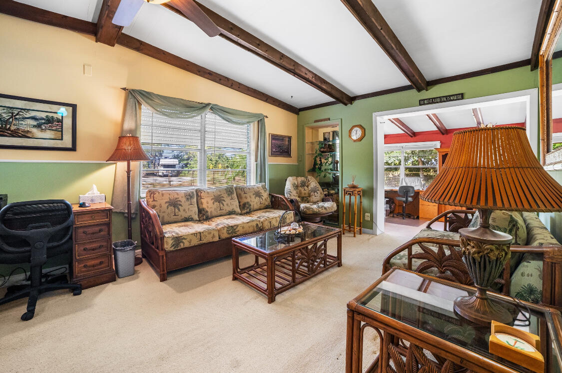 3966 Northwest 20th Avenue Okeechobee, FL 34972 - Photo 13 of 35 a living room with furniture and a flat screen tv