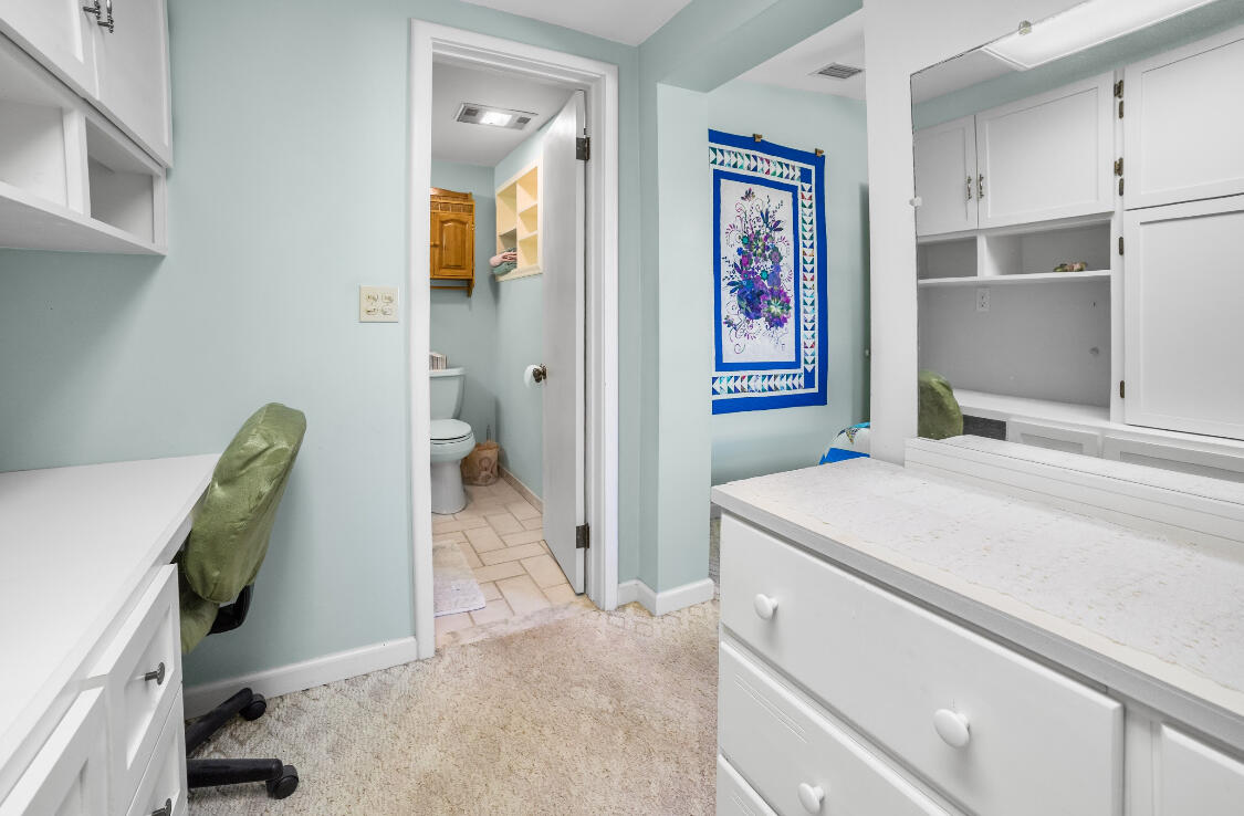 3966 Northwest 20th Avenue Okeechobee, FL 34972 - Photo 19 of 35 a bedroom with a bed and a view of kitchen