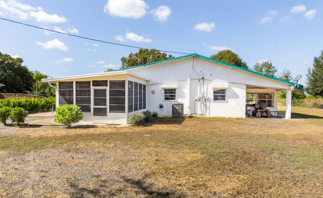3966 Northwest 20th Avenue Okeechobee, FL 34972 - Photo 2 of 35 a view of a house with a patio and yard