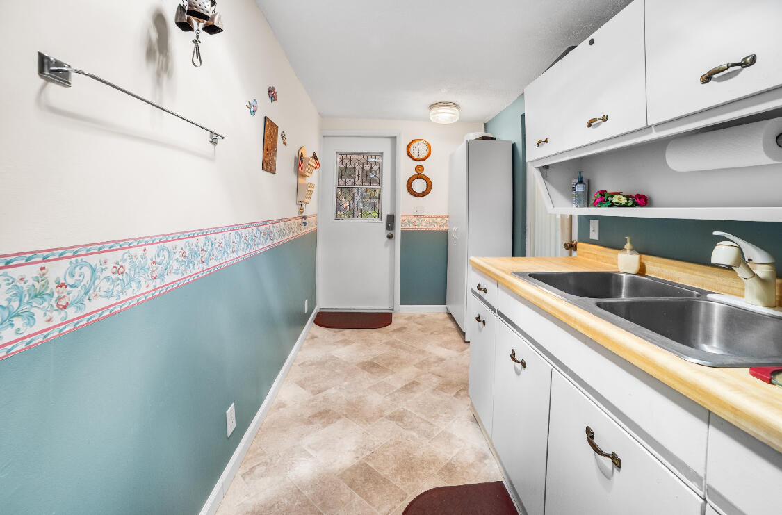3966 Northwest 20th Avenue Okeechobee, FL 34972 - Photo 25 of 35 a kitchen with granite countertop a sink and cabinets
