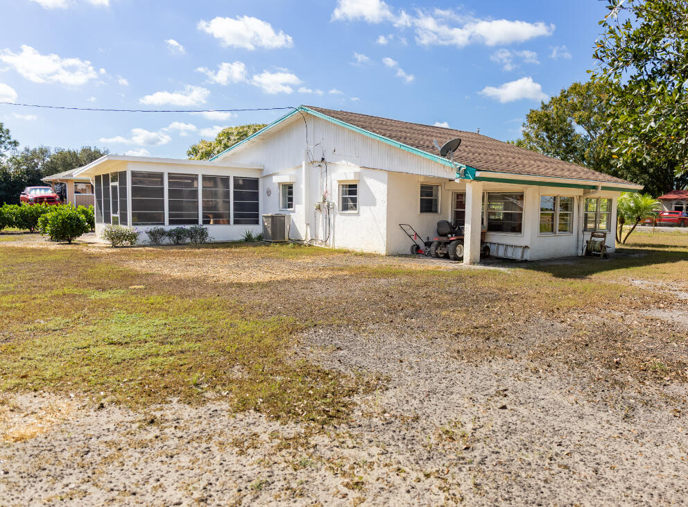 3966 Northwest 20th Avenue Okeechobee, FL 34972 - Photo 30 of 35 a view of a house next to a big yard and large trees