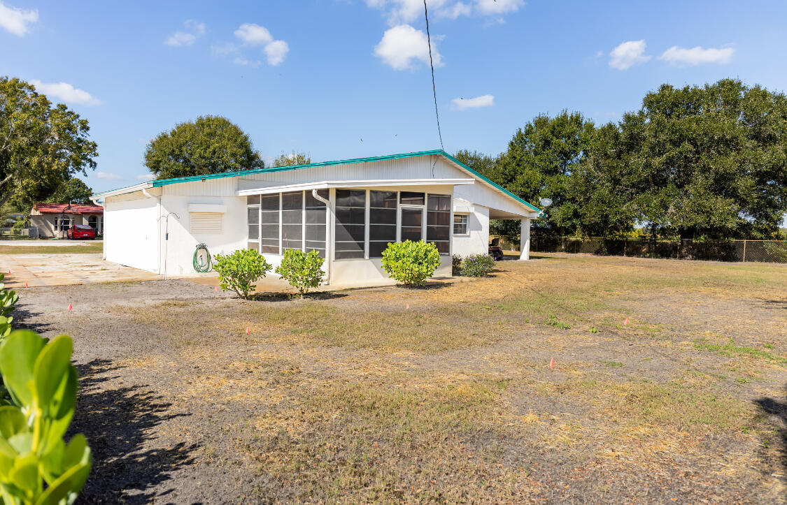 3966 Northwest 20th Avenue Okeechobee, FL 34972 - Photo 32 of 35 a front view of a house with garden