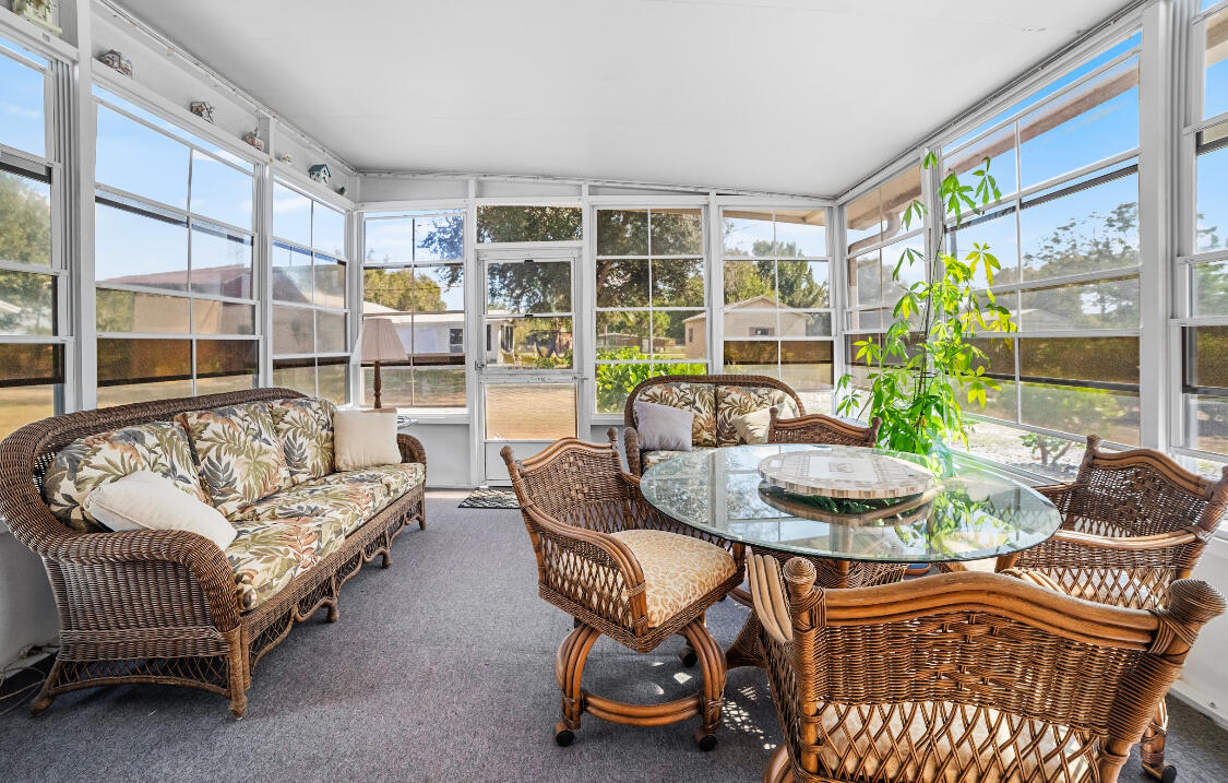 3966 Northwest 20th Avenue Okeechobee, FL 34972 - Photo 9 of 35 a living room with furniture and a large window