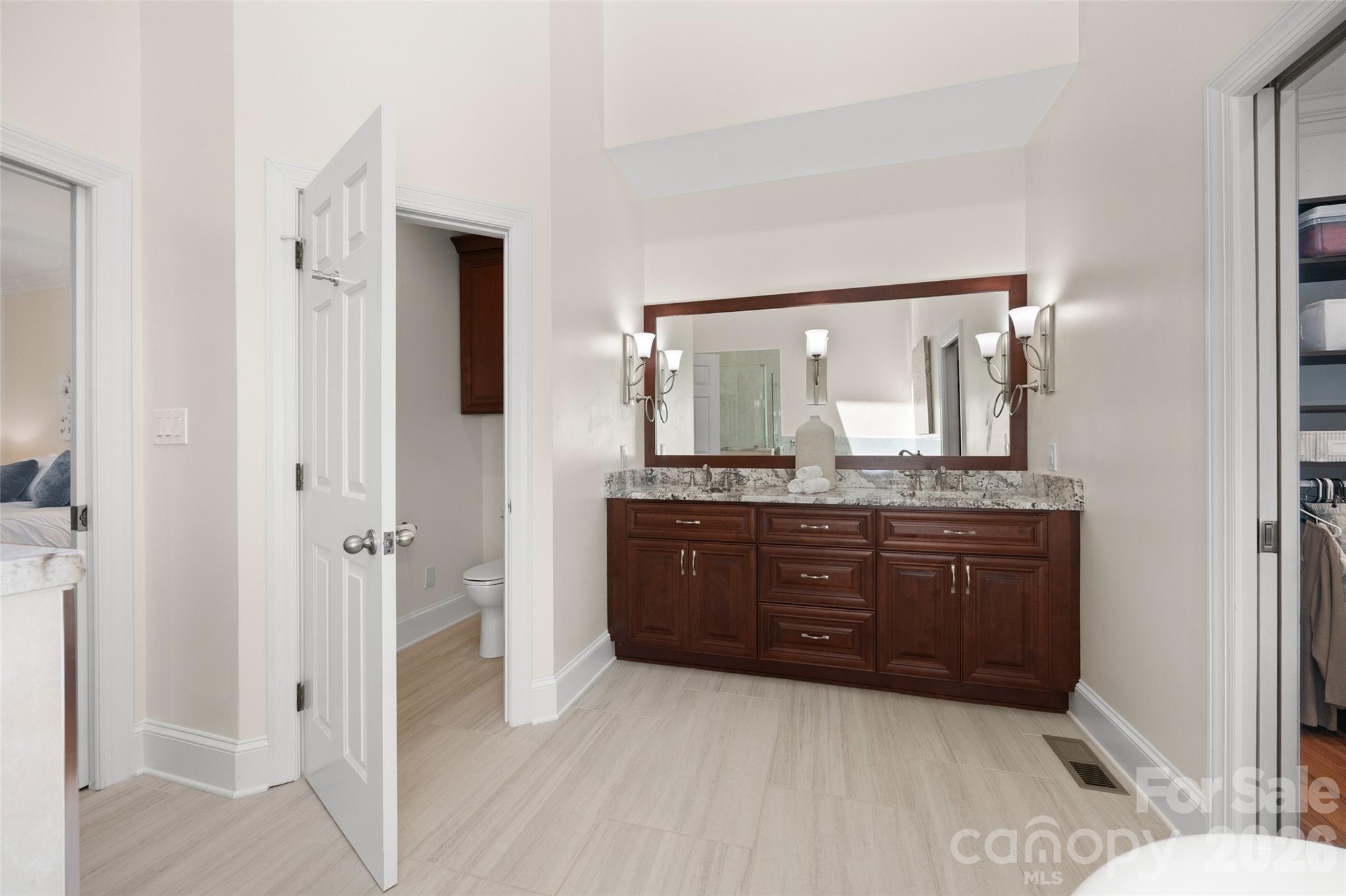 636 Landsdowne Court Fort Mill, SC 29708 - Photo 20 of 48 a bathroom with a granite countertop sink a mirror and a shower