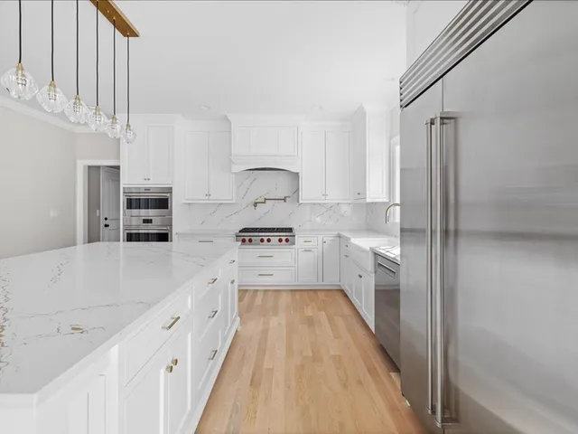 a kitchen with stainless steel appliances sink refrigerator and stove