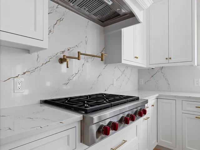 a stove top oven sitting inside of a kitchen