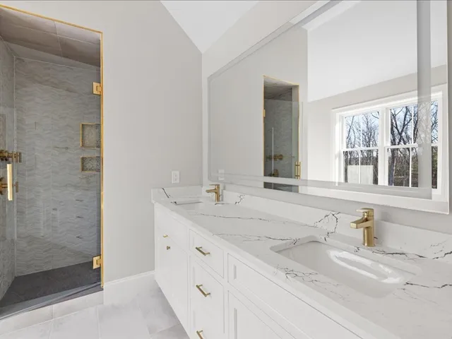 a bathroom with a granite countertop sink mirror and double