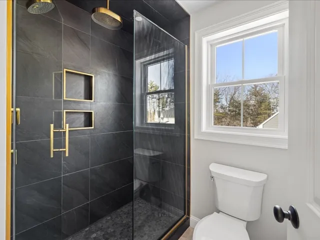 a white toilet sitting next to a bathroom sink
