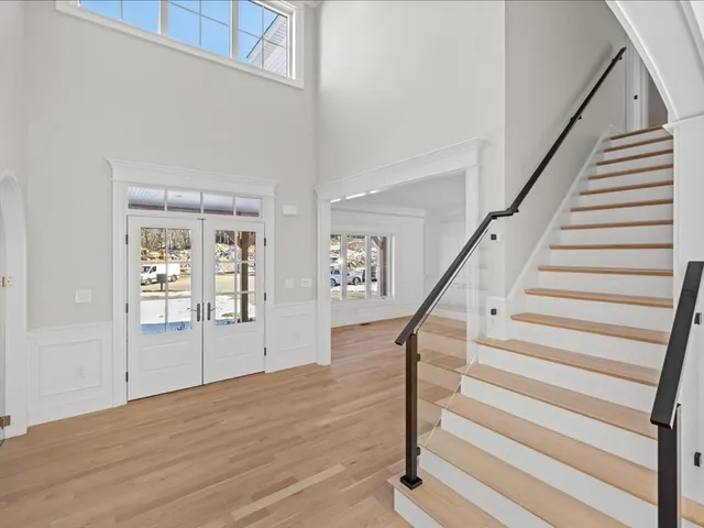 a view of entryway and hall with wooden floor