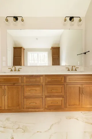 a bathroom with a sink vanity and a mirror