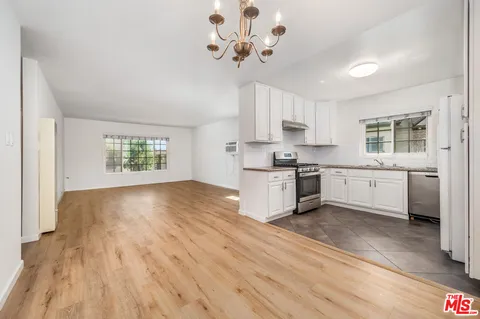 a kitchen with a cabinets wooden floor and a stove top oven