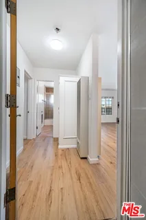 a view of hallway with wooden floor