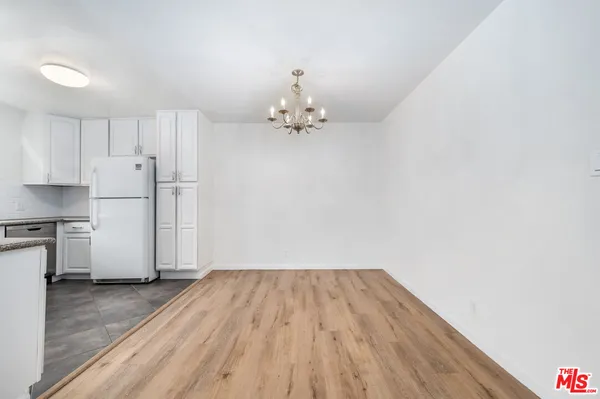 a view of a kitchen with a dishwasher cabinets and wooden floor