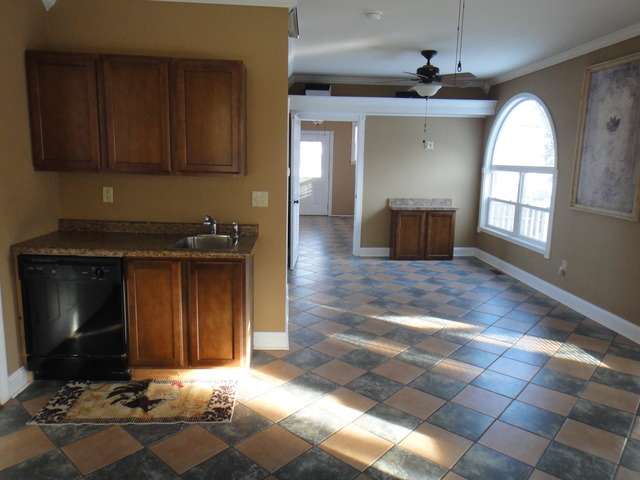 401 South Malta Road Malta, IL 60150 - Photo 14 of 25 a living room with stainless steel appliances kitchen island granite countertop a stove a sink and a microwave