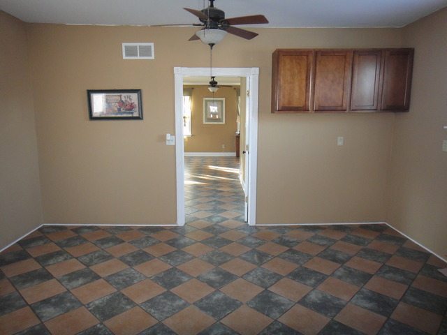 401 South Malta Road Malta, IL 60150 - Photo 15 of 25 an empty room with a ceiling fan and window