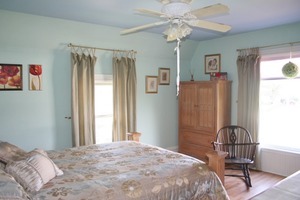 401 South Malta Road Malta, IL 60150 - Photo 19 of 25 a bedroom with a bed and a chandelier