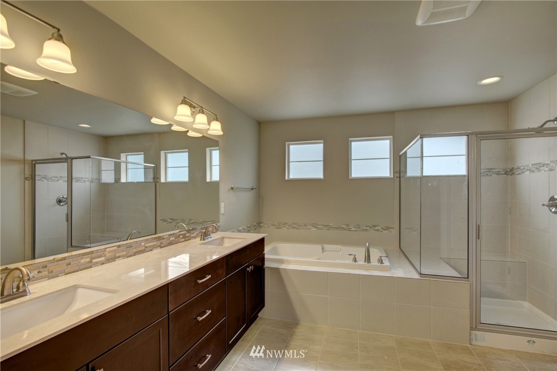3530 178th Place Southeast, Unit 3013 Bothell, WA 98012 - Photo 5 of 11 a bathroom with a tub double sink and mirror