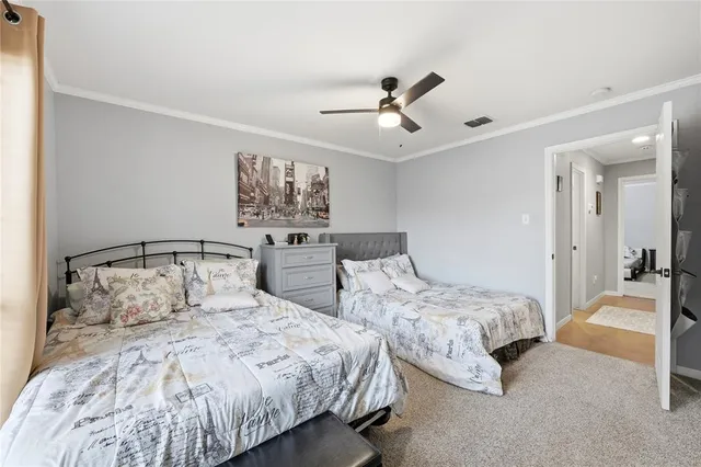 a bedroom with two beds and a chandelier