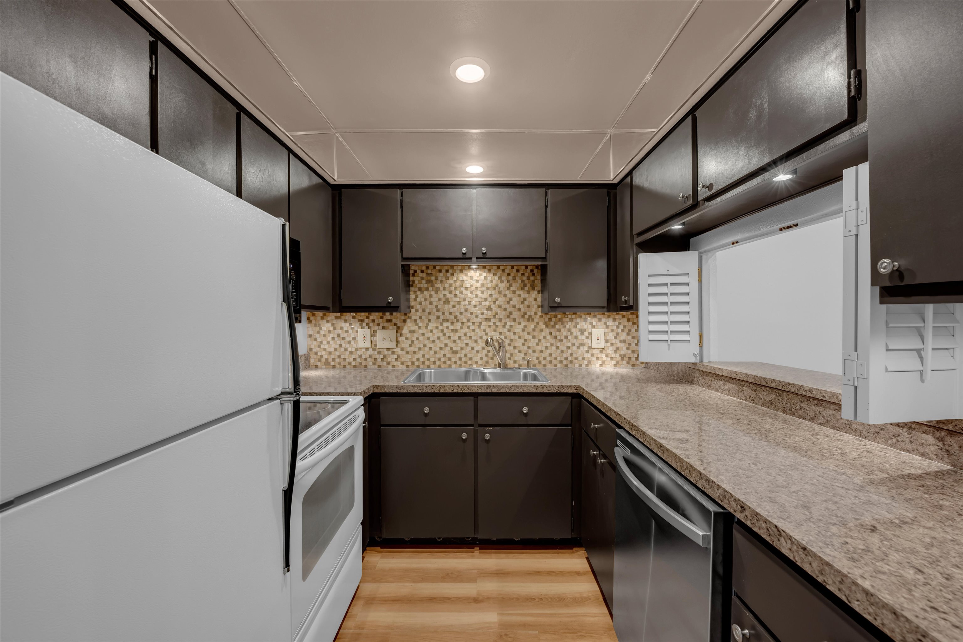 1206 Hi Stirrup Horseshoe Bay, TX 78657 - Photo 11 of 25 a kitchen with stainless steel appliances granite countertop a sink and a refrigerator