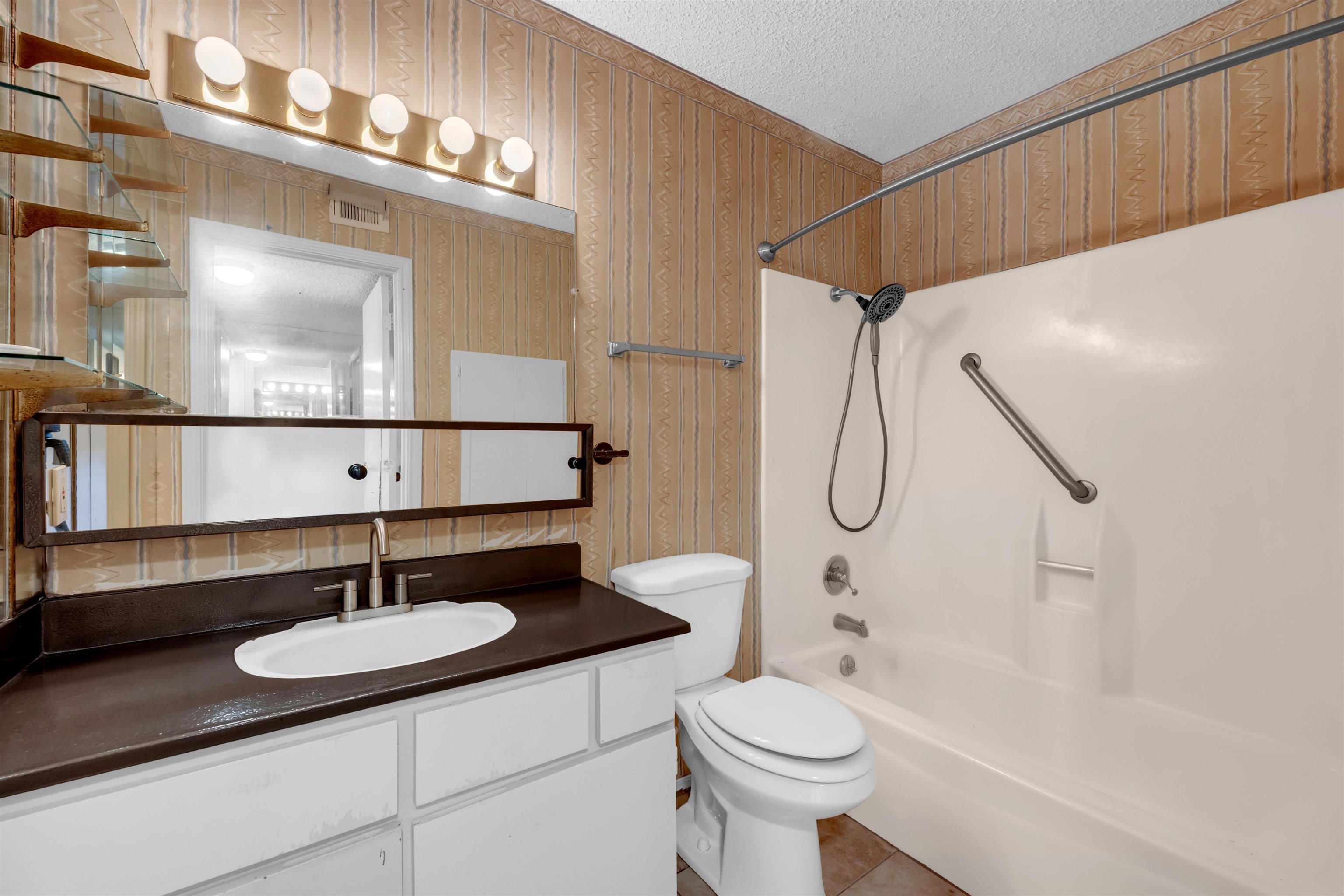 1206 Hi Stirrup Horseshoe Bay, TX 78657 - Photo 15 of 25 a bathroom with a sink a toilet and a mirror