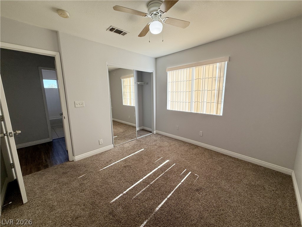 2185 Polynesia Circle Henderson, NV 89074 - Photo 18 of 37 A well-lit room offers comfort with plush carpeting and a ceiling fan.