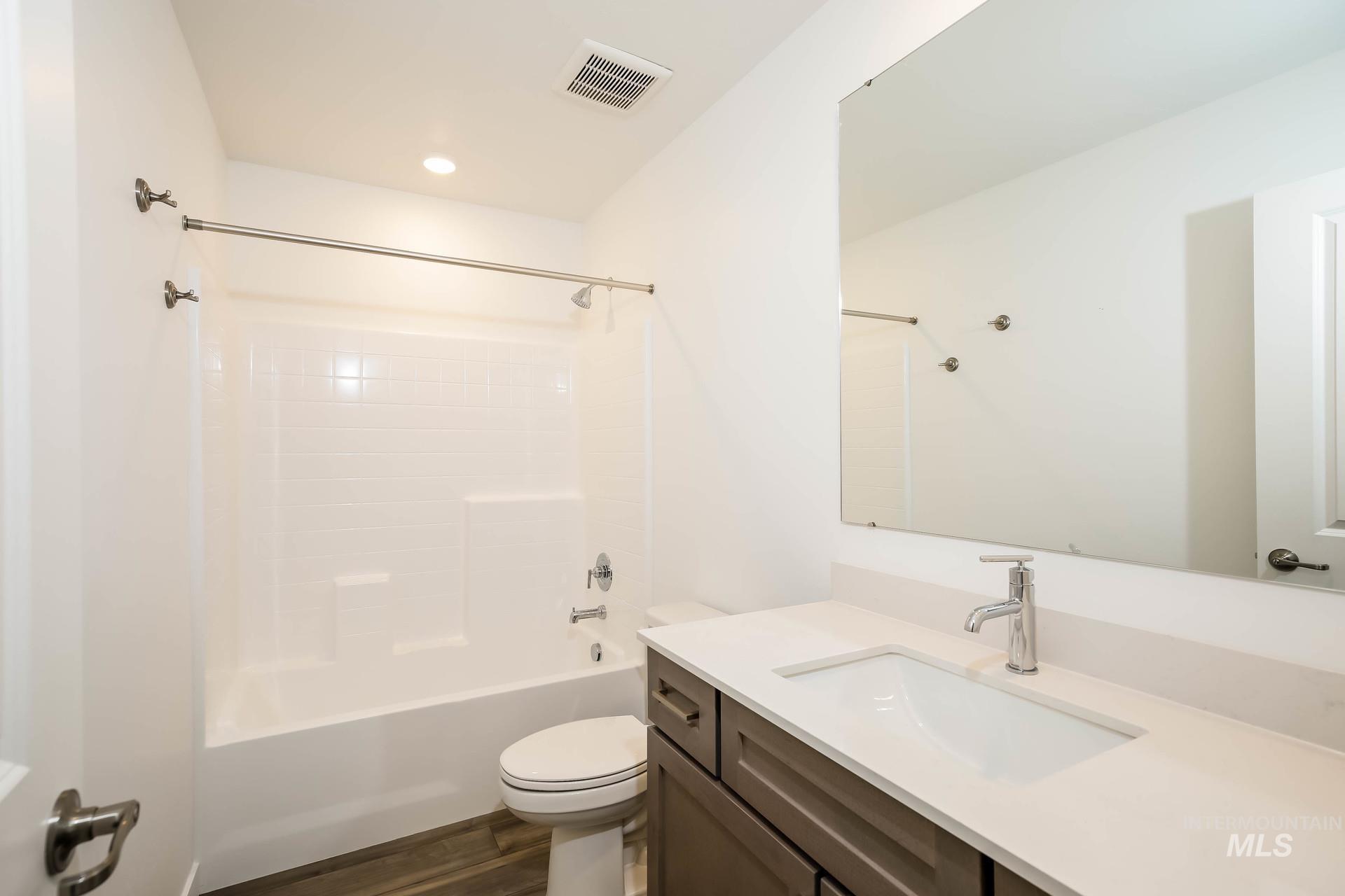 1918 East Springloyd Street Meridian, ID 83642 - Photo 10 of 20 White bathtub and shower combination with a textured surround
