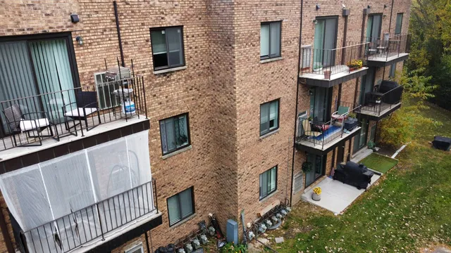 a view of a brick house with many windows
