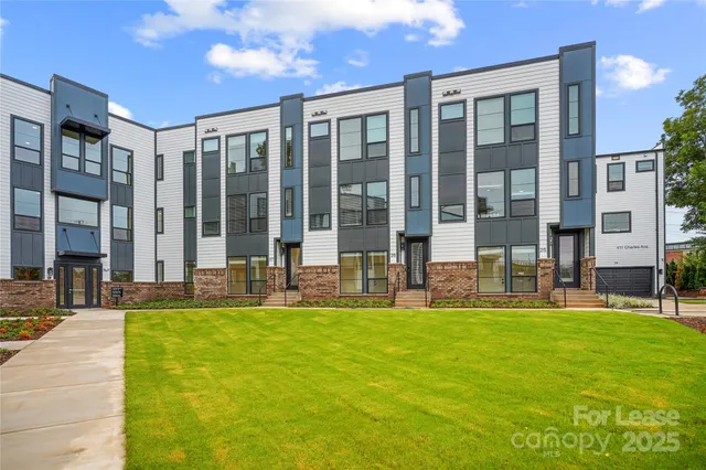 a kitchen with stainless steel appliances kitchen island granite countertop a stove a sink a dining table and chairs with wooden floor