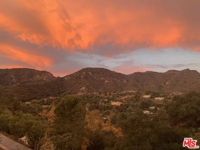 a view of a mountain range in a cloudy sky