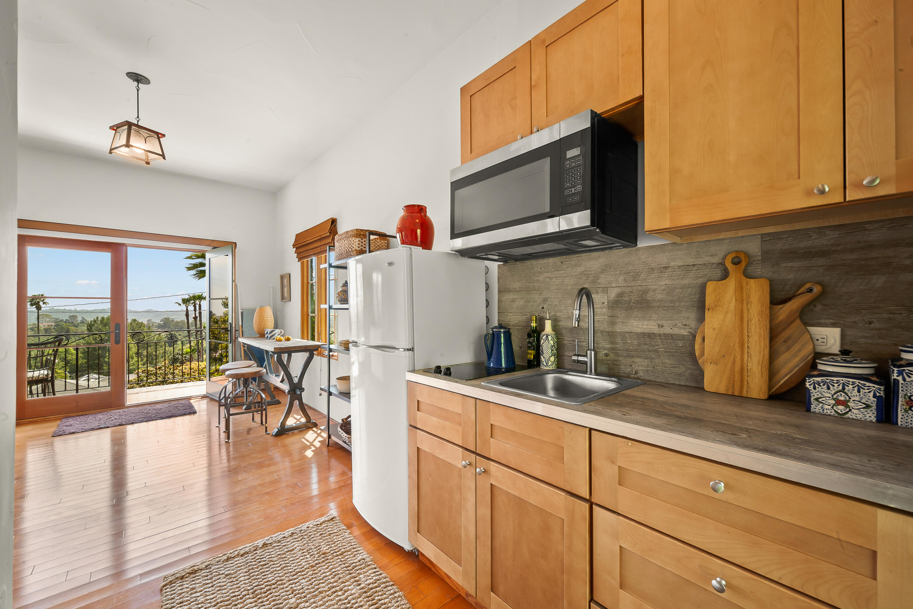 870 Windsor Way Santa Barbara, CA 93105 - Photo 16 of 59 a kitchen with granite countertop a sink and a stove top oven