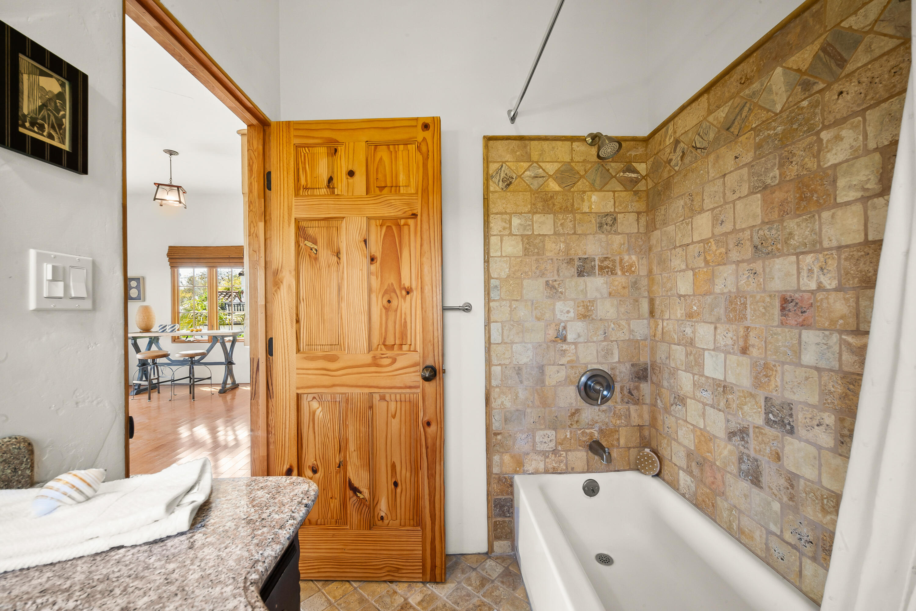 870 Windsor Way Santa Barbara, CA 93105 - Photo 17 of 59 a bathroom with a granite countertop tub a sink and a shower