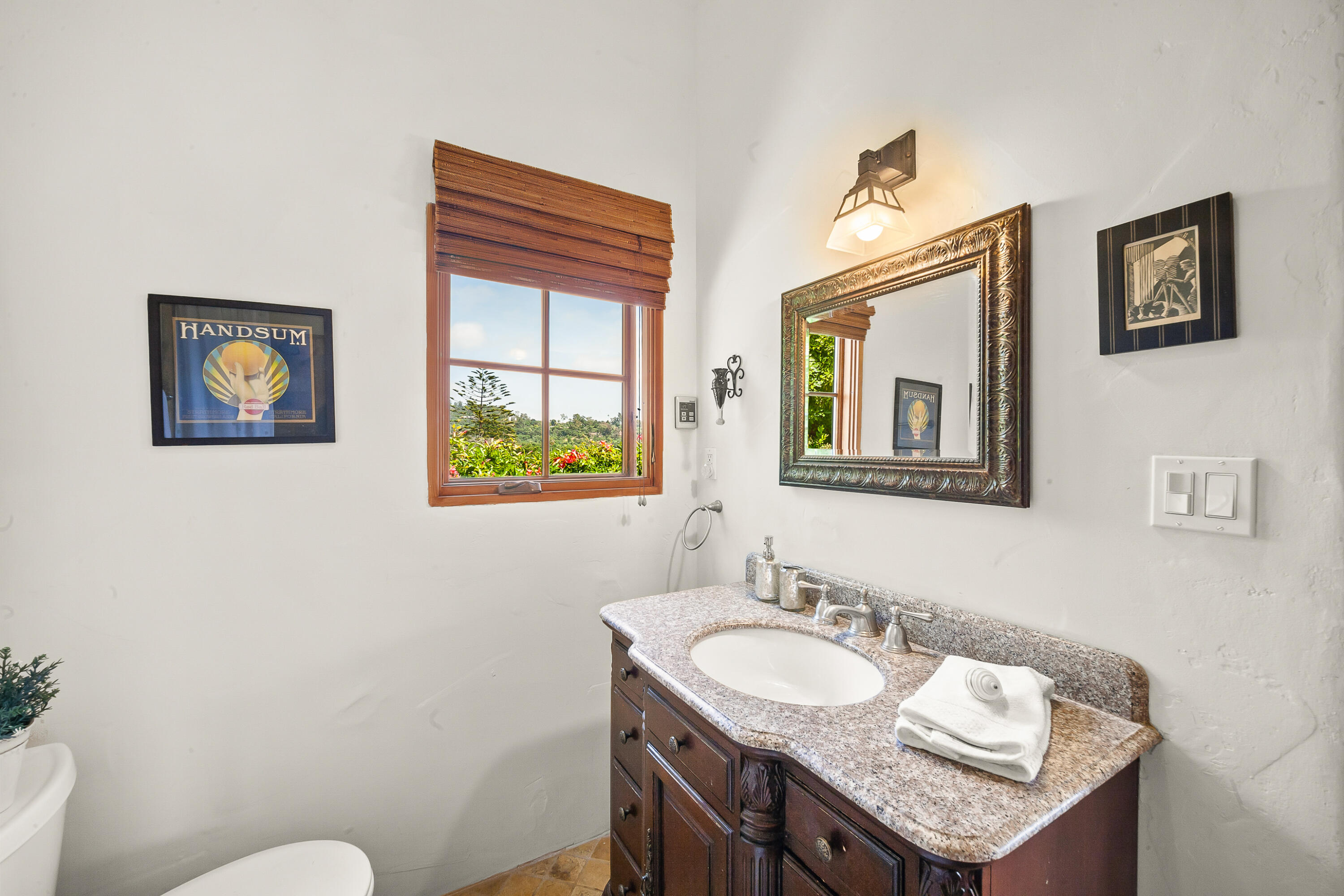 870 Windsor Way Santa Barbara, CA 93105 - Photo 18 of 59 a bathroom with a granite countertop sink and a mirror