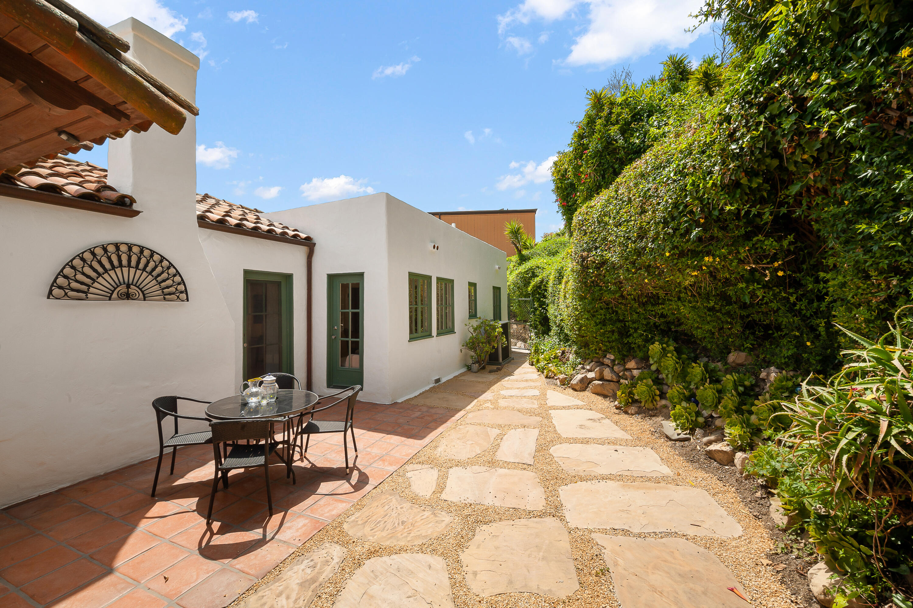 870 Windsor Way Santa Barbara, CA 93105 - Photo 47 of 59 a view of a patio with table and chairs and potted plants