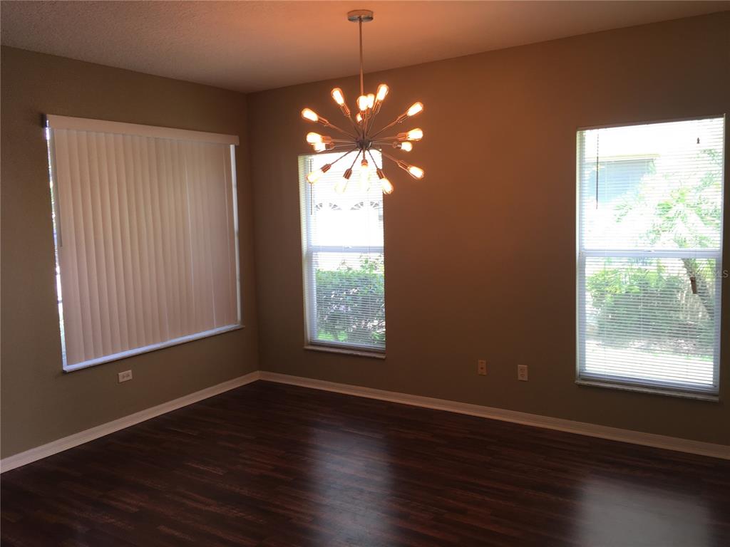 18047 Java Isle Drive Tampa, FL 33647 - Photo 3 of 21 a view of an empty room with wooden floor and a window