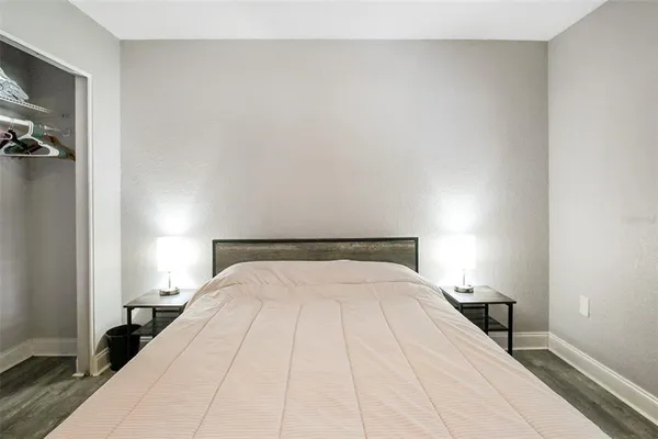 a bedroom with a bed and a night stand