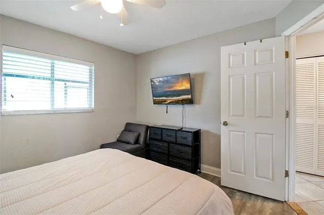 a bedroom with a bed and a flat screen tv