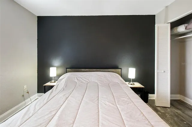 a bedroom with a bed and a night stand