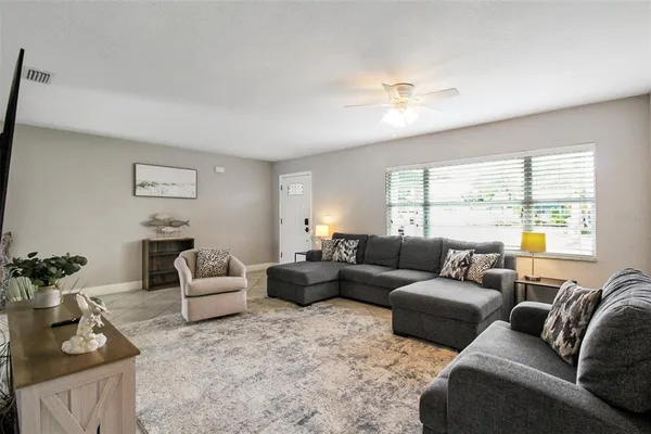 a living room with furniture and a large window