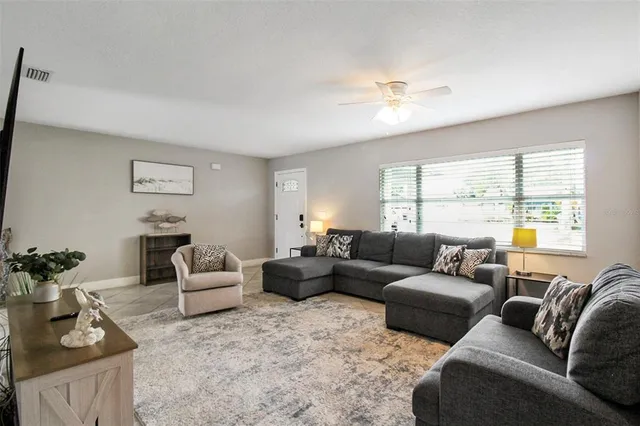 a living room with furniture and a large window