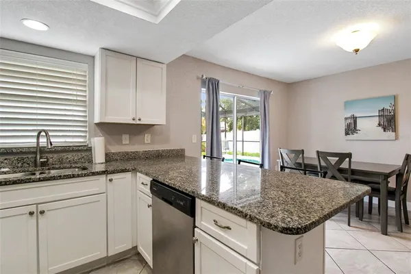 a kitchen with granite countertop kitchen island a counter space a sink and appliances