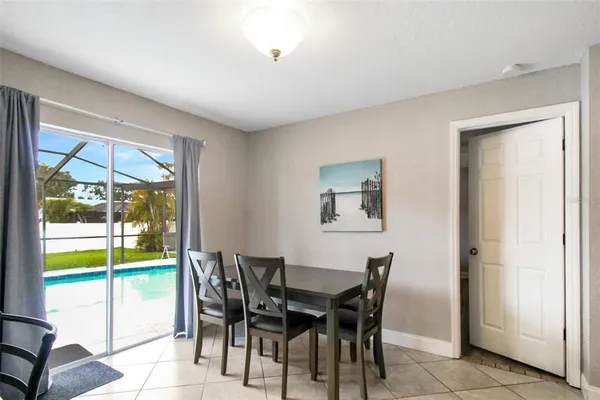 a dining room with furniture and a floor to ceiling window